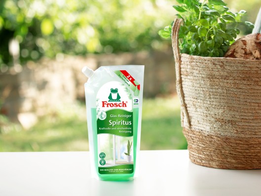 A Frosch bio-spirit glass cleaner refill pouch stands next t