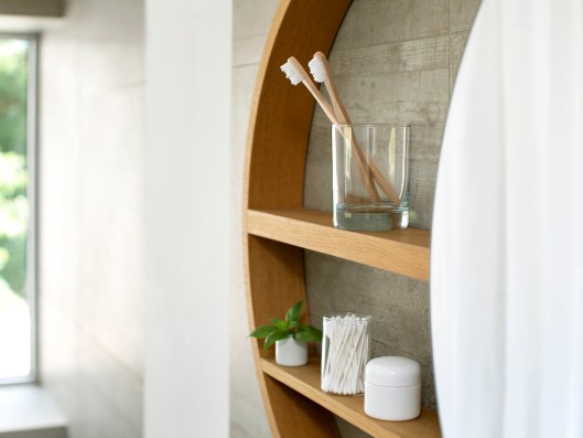 Mirrored cabinet with toothbrushes and hygiene products next